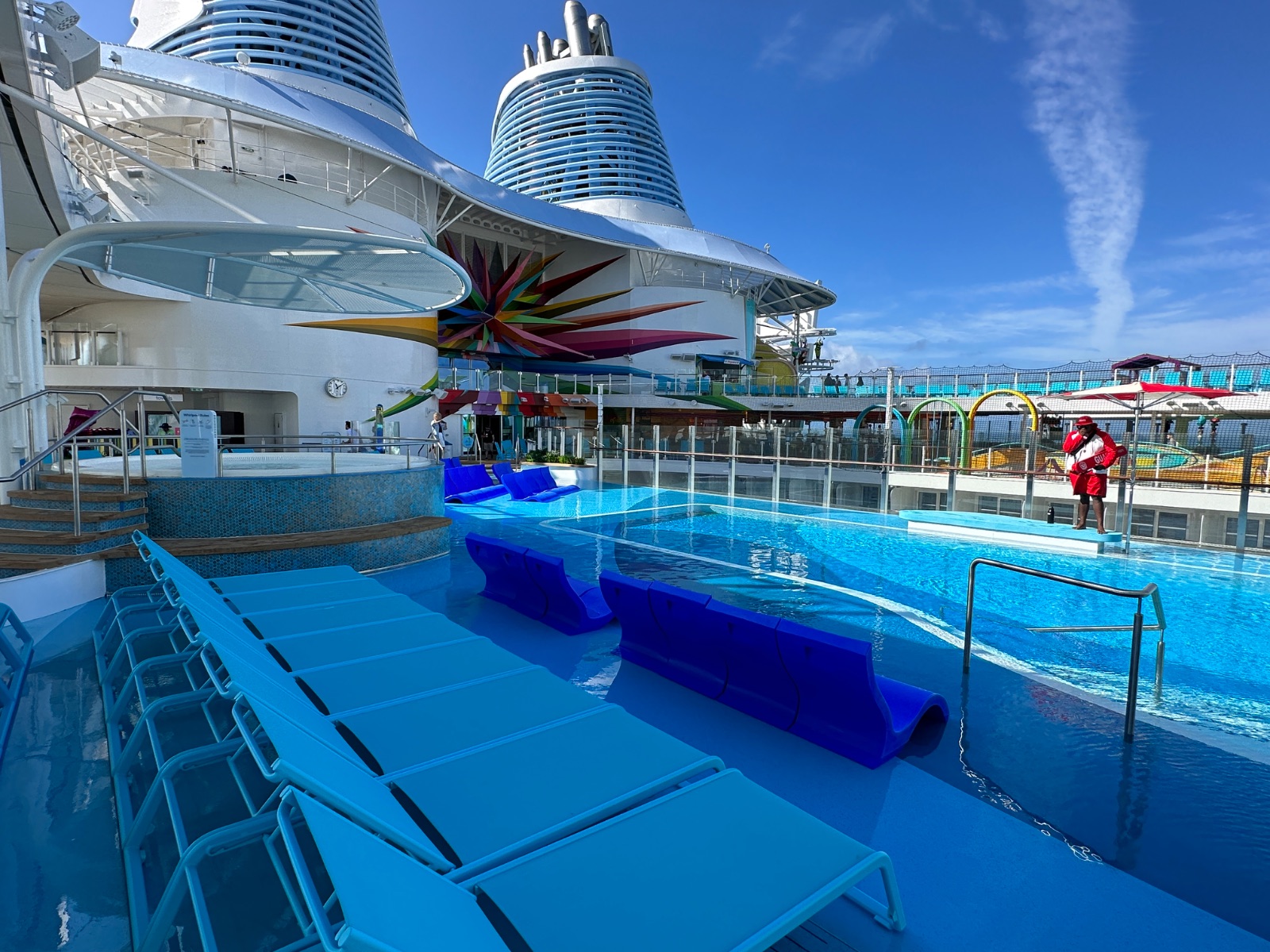 The main pool deck on Icon of the Seas, with sun loungers lining a bright blue pool. Photo: Dreams Fulfilled Travel Dream Designer