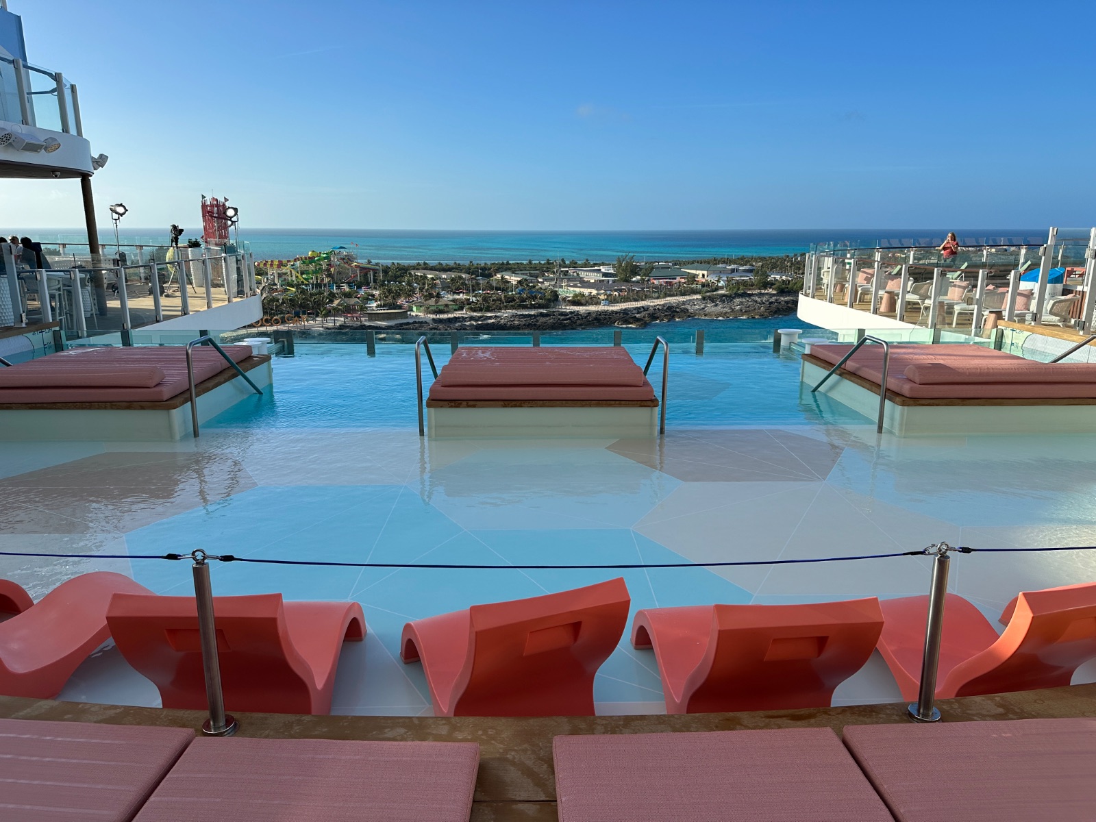 The adults-only Hideaway on Icon of the Seas, where red loungers frame a suspended infinity pool overlooking the sea. Photo: Dreams Fulfilled Travel Dream Designer