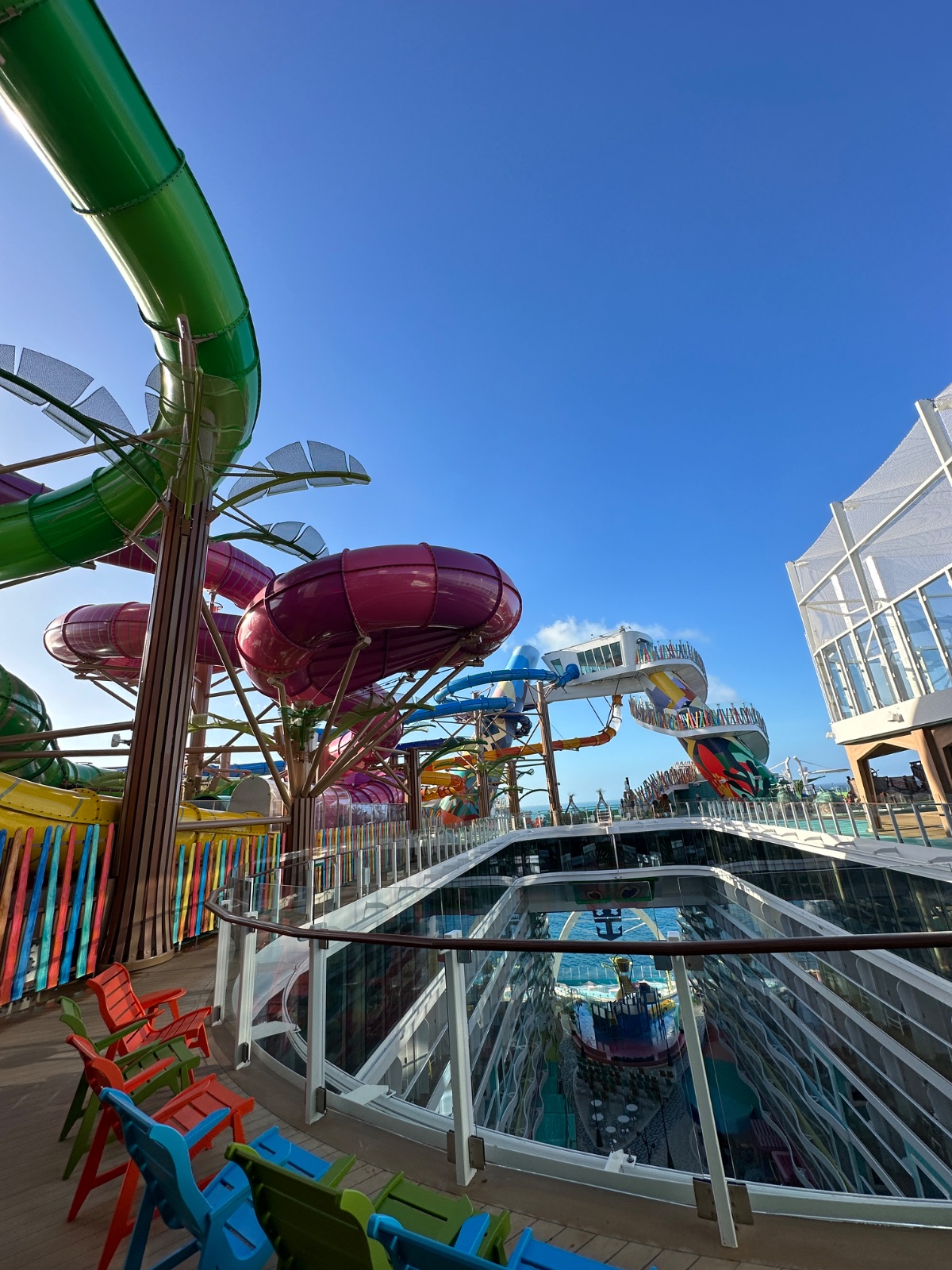 Water slides twisting above the Category 6 waterpark on Icon of the Seas against a clear blue sky. Photo: Dreams Fulfilled Travel Dream Designer