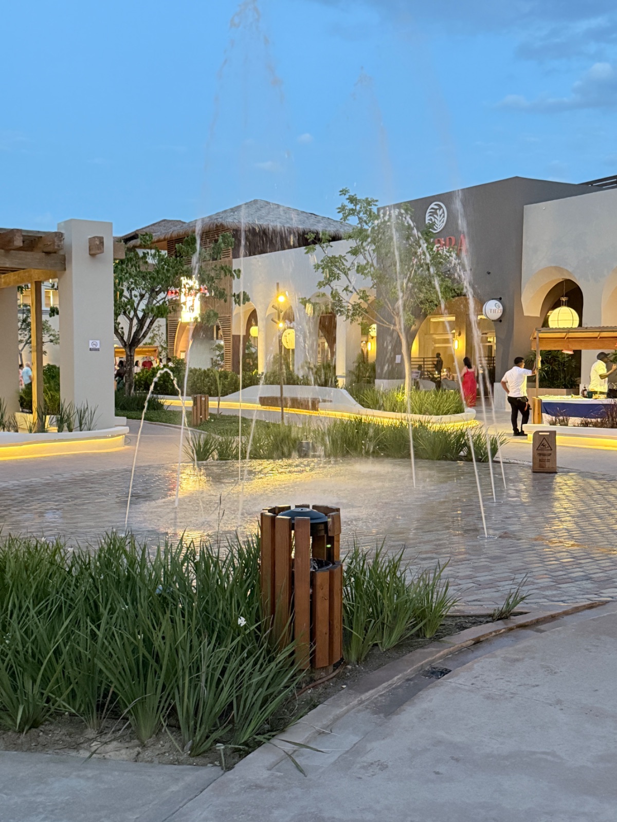 The resort's central plaza at dusk, with fountains and warm lighting. Photo: Dreams Fulfilled Travel Dream Designer